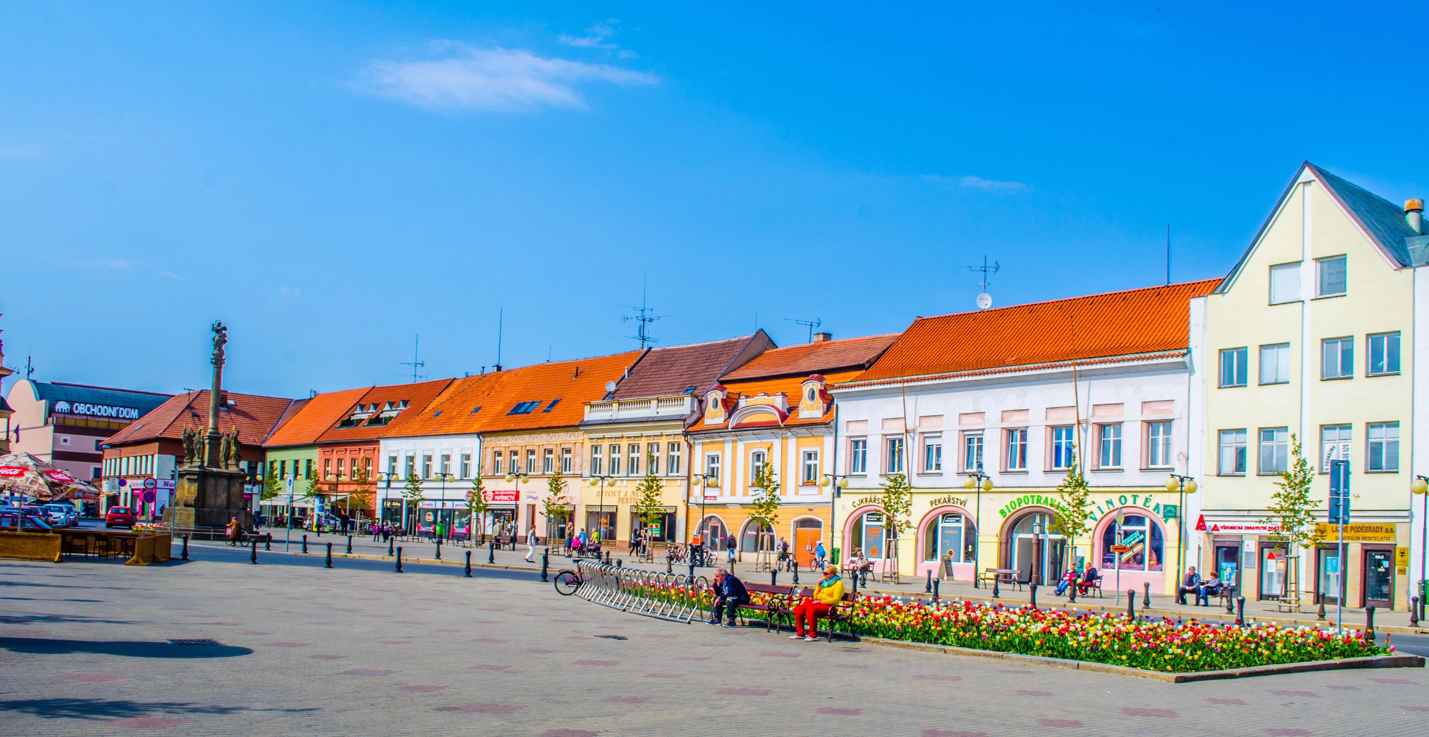 Centrum českého města s barevnými domy a lidmi na ulici,
