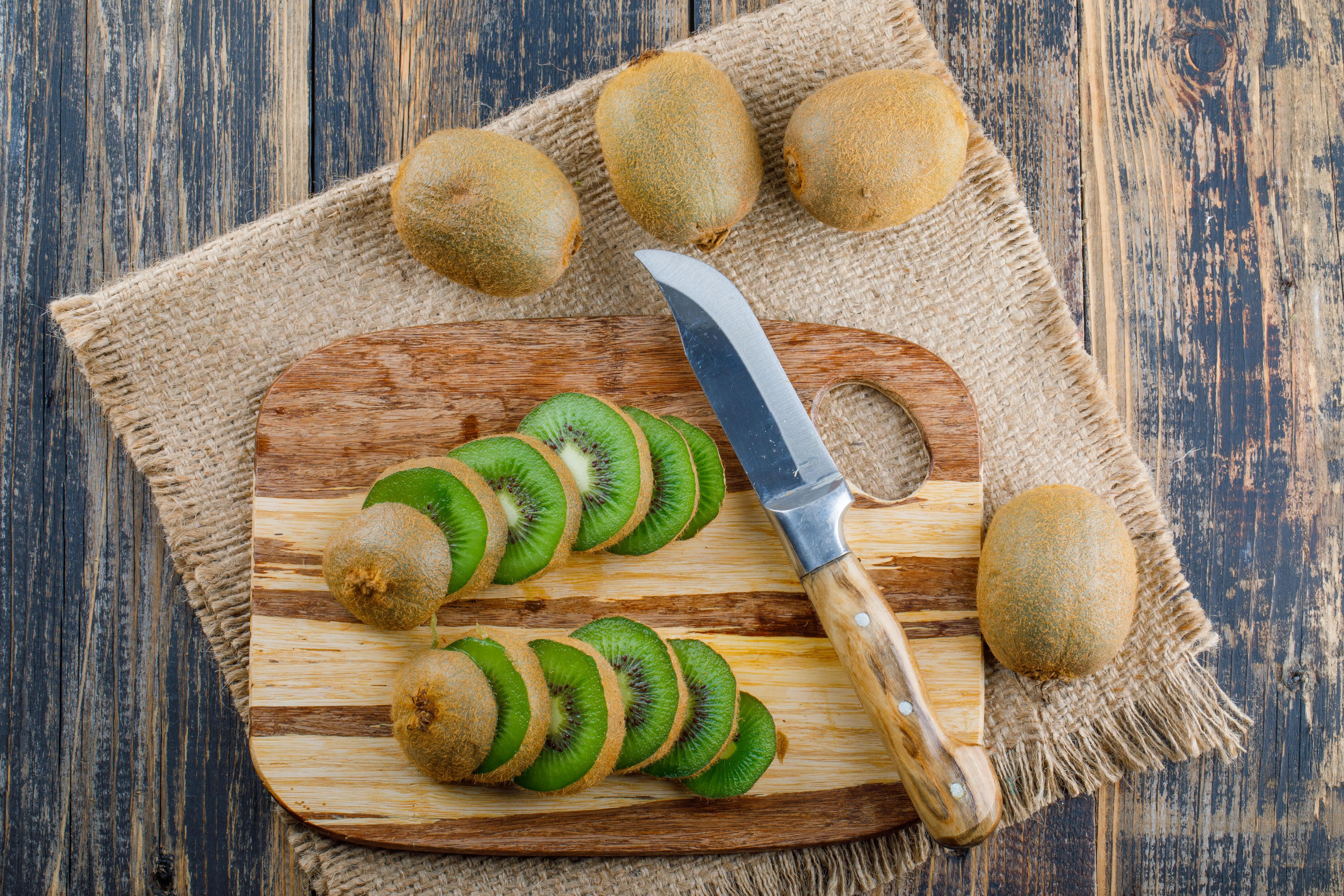 Čerstvé kiwi v misce s citrusy na kuchyňské lince